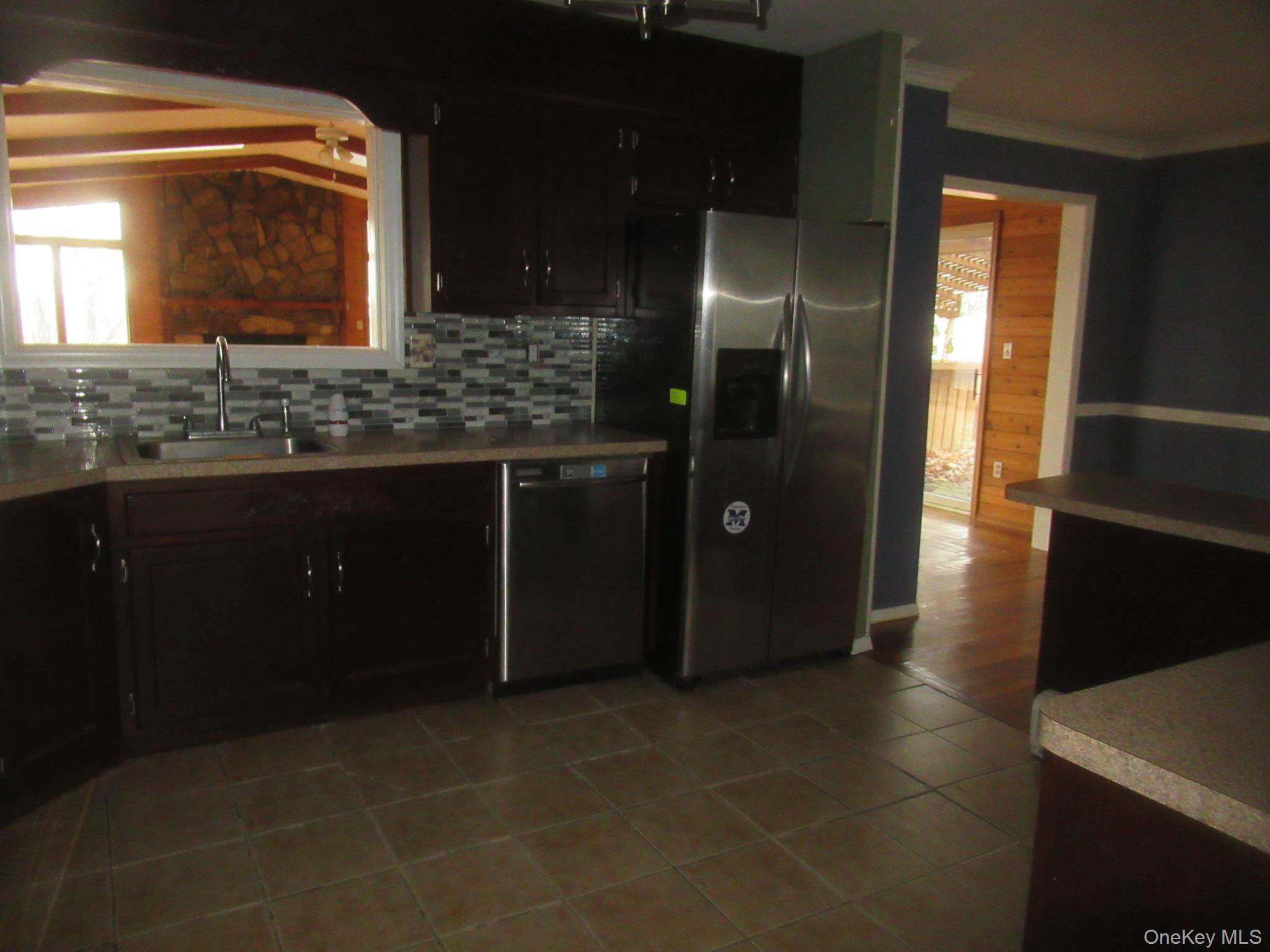 64 Hillside View Road Mahopac, NY 10541 - Photo 5 of 25 Kitchen with appliances with stainless steel finishes, tasteful backsplash, light countertops, light tile patterned floors, and vaulted ceiling
