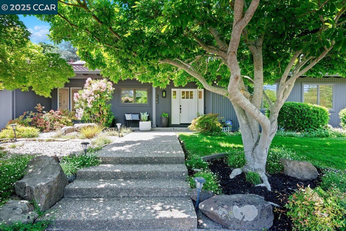 a front view of a house with garden