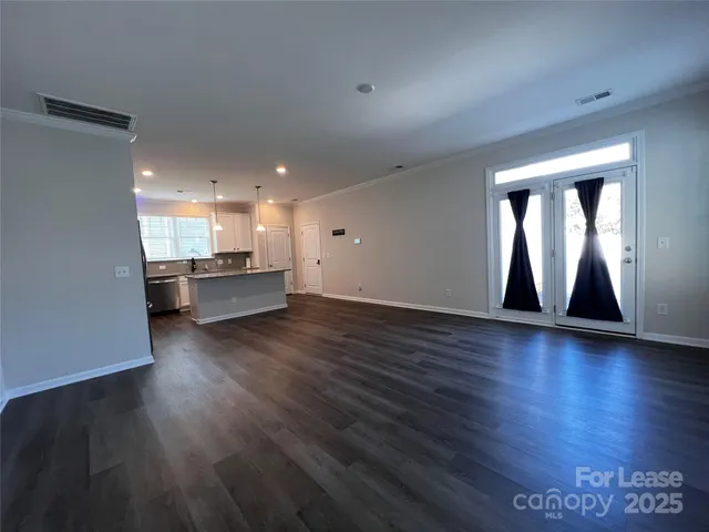 a view of kitchen and hall with wooden floor