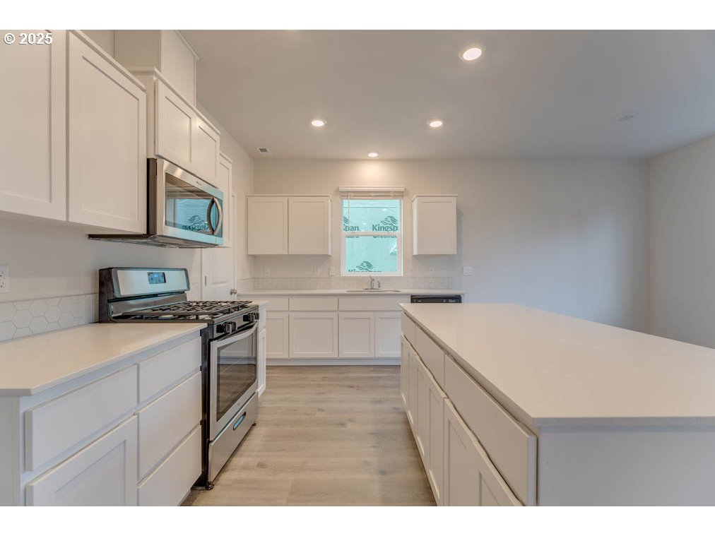 2967 U Street Springfield, OR 97477 - Photo 3 of 20 a kitchen that has a sink a stove and cabinets