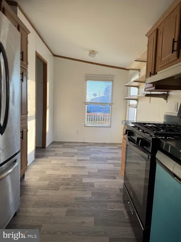 a kitchen with stainless steel appliances granite countertop a stove and a refrigerator
