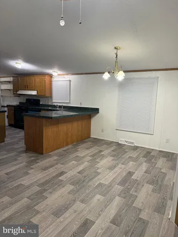 a view of kitchen with microwave and stove