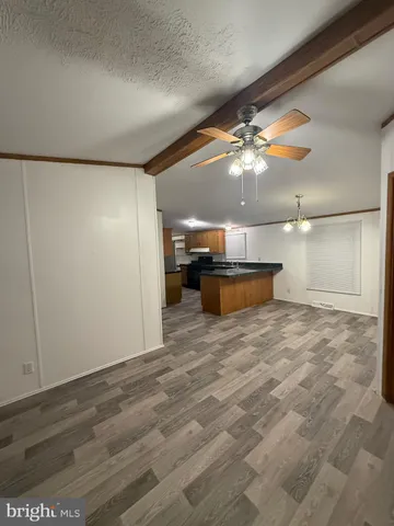 a view of a room with a kitchen