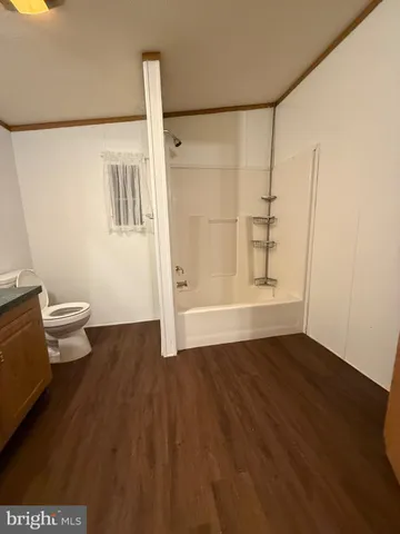 a bathroom with a granite countertop toilet and a sink
