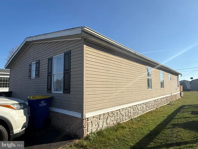 a back view of a house with a yard