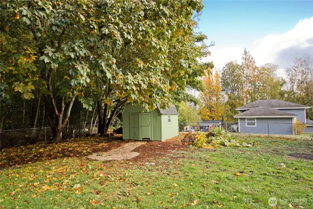 a backyard of a house with table and chairs