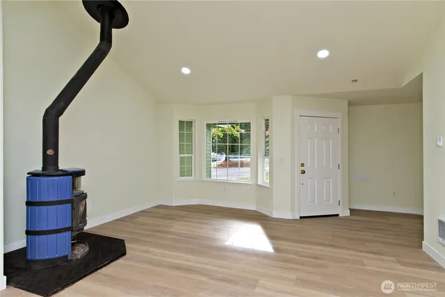 a view of wooden floor and windows in a room