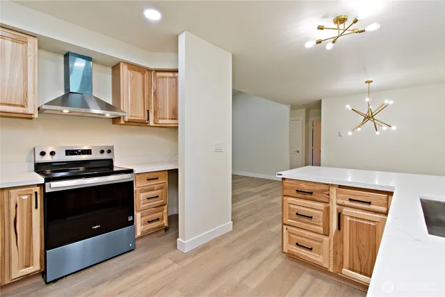 a kitchen with stainless steel appliances a stove a refrigerator and cabinets