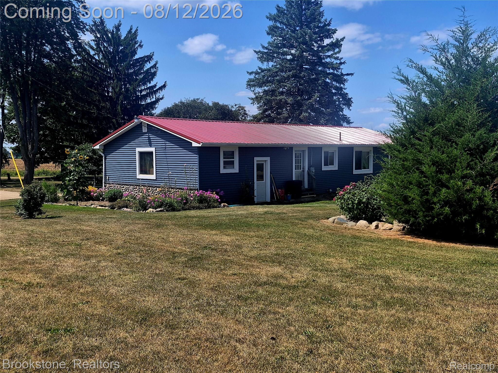 8426 Lake Pleasant Road Clifford, MI 48727 - Photo 23 of 33 Charming single-story residence featuring a distinctive red metal roof and horizontal siding exterior
