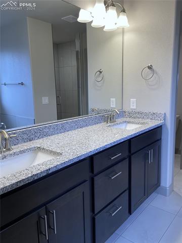 9083 Peaceful Valley Road Colorado Springs, CO 80925 - Photo 13 of 22 Bathroom featuring dual bowl vanity, tile flooring, and ceiling fan