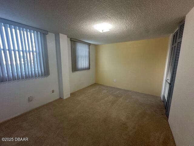 2727 North Atlantic Avenue, Unit 211 Daytona Beach, FL 32118 - Photo 24 of 38 an empty room with windows