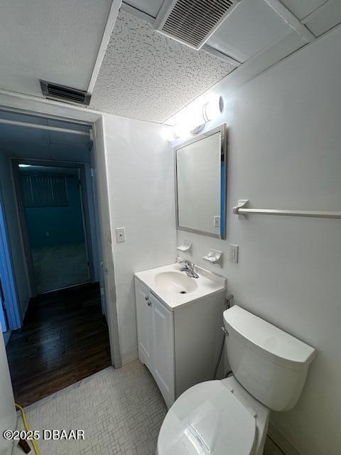 2727 North Atlantic Avenue, Unit 211 Daytona Beach, FL 32118 - Photo 25 of 38 a bathroom with a toilet sink and mirror