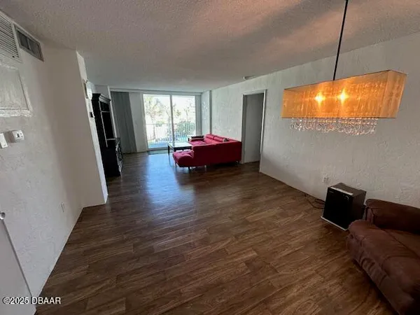 a kitchen with refrigerator cabinets and wooden floor