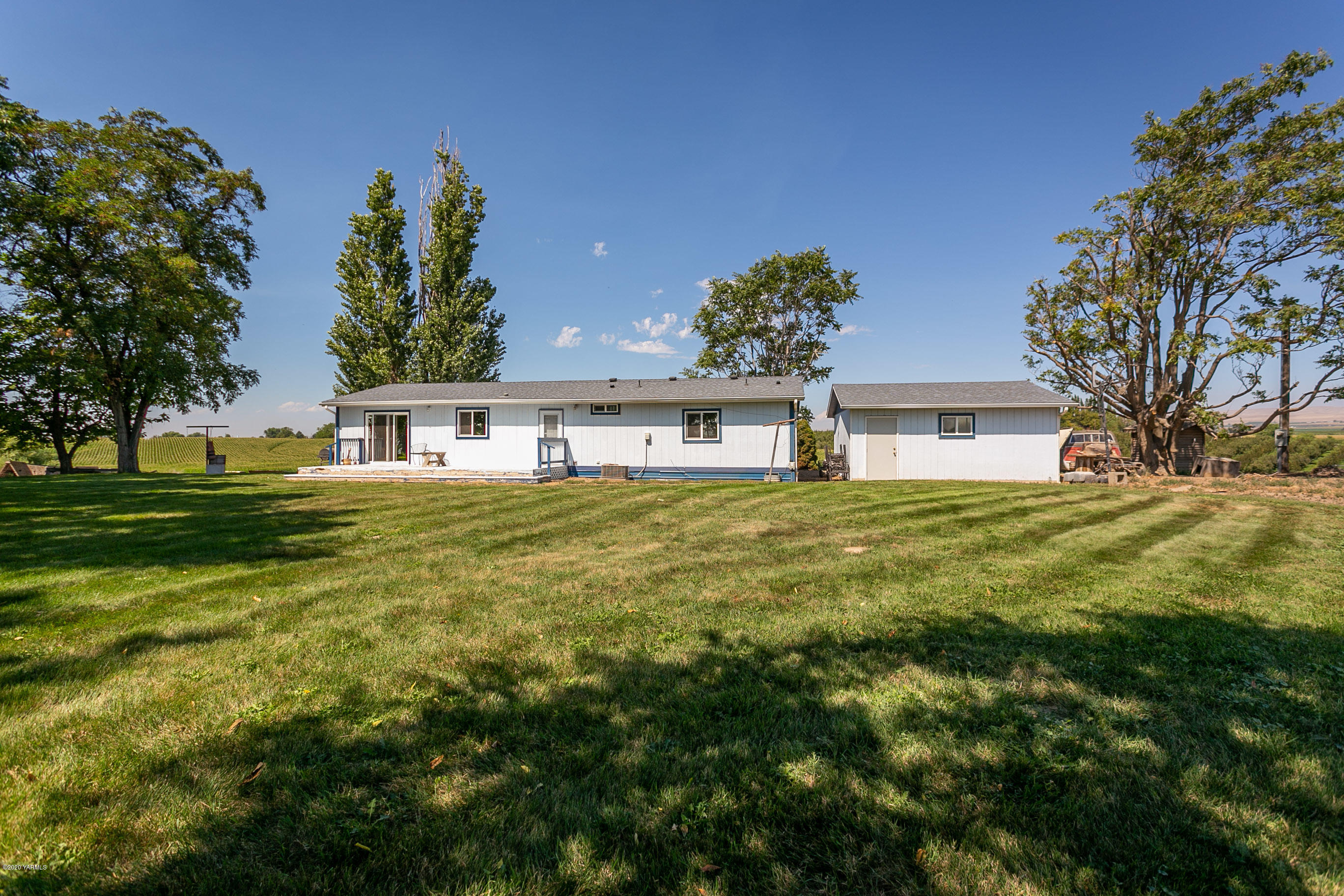2110 Dekker Road Outlook, WA 98938 - Photo 22 of 30 a white house with a big yard and large trees