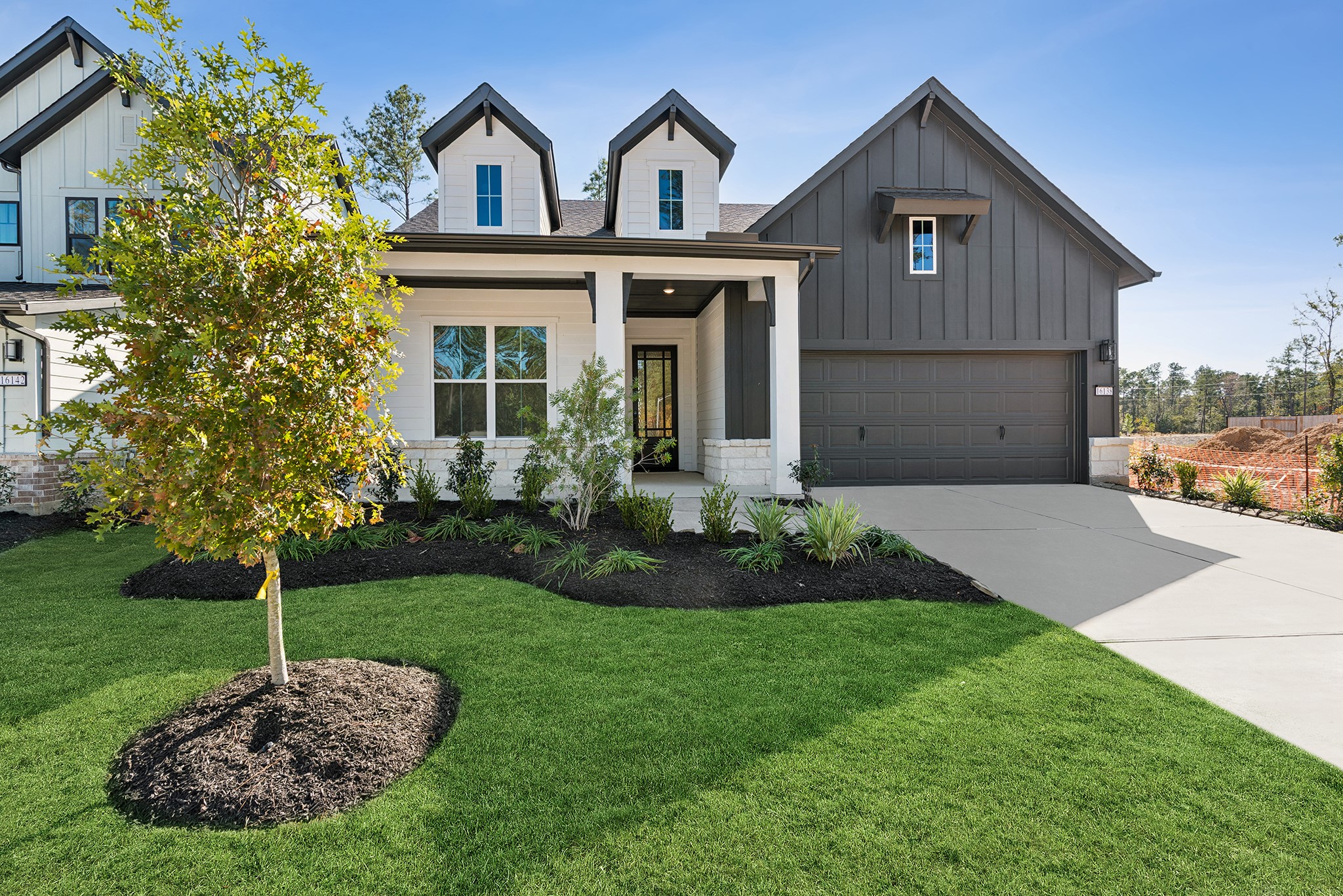 16138 Rita Road Conroe, TX 77302 - Photo 2 of 50 a front view of a house with garden
