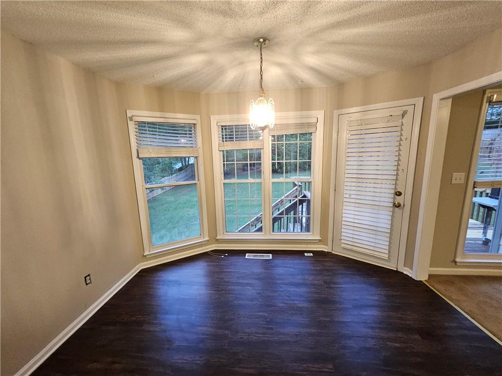 144 Hunters Trace Dallas, GA 30157 - Photo 11 of 34 an empty room with wooden floor and windows
