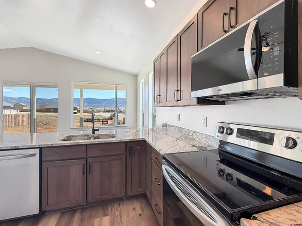 a kitchen with a sink and stainless steel appliances