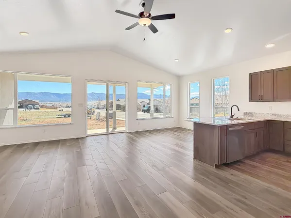 a kitchen with refrigerator cabinets and wooden floor