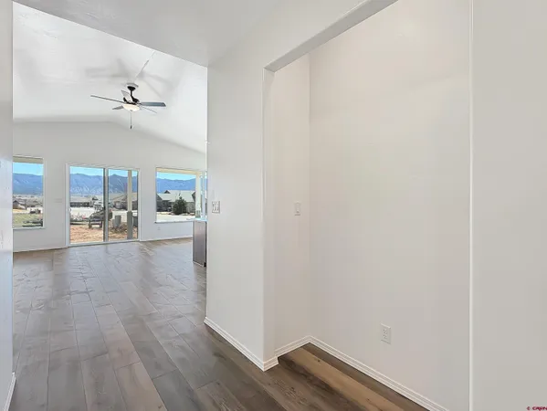 a view of a room with wooden floor and glass door