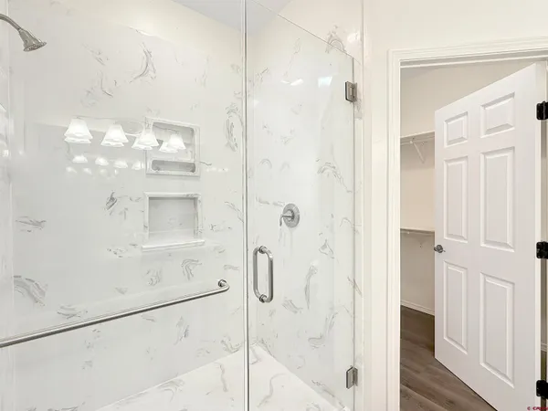 an empty room with wooden floor and window