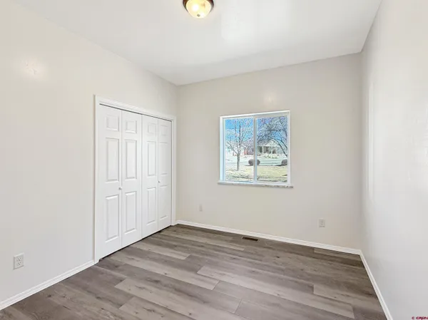 a view of a kitchen with a sink a refrigerator and window