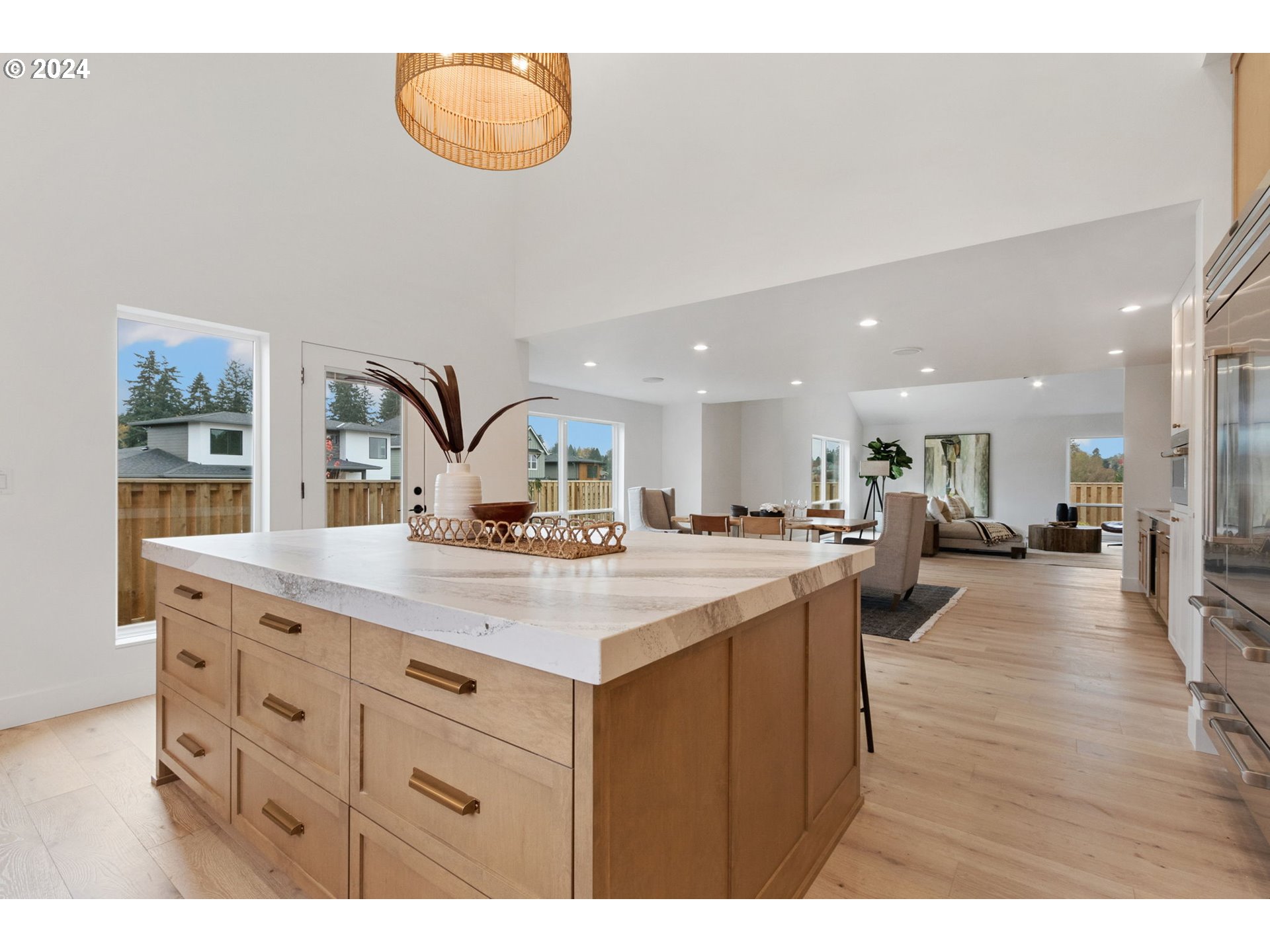 23141 Southwest Curry Ridge Drive Sherwood, OR 97140 - Photo 20 of 47 a kitchen with kitchen island a stove and a wooden floors