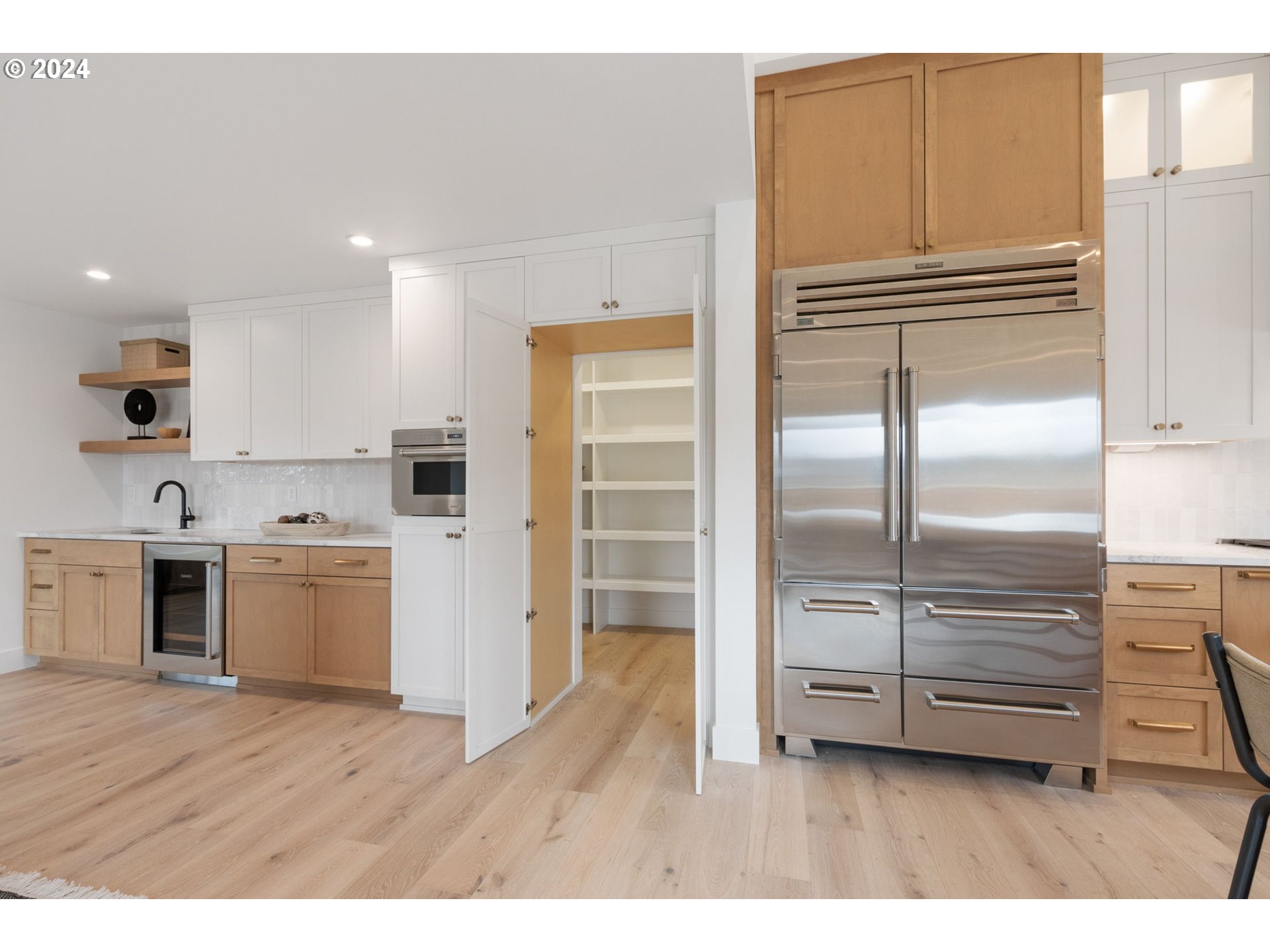 23141 Southwest Curry Ridge Drive Sherwood, OR 97140 - Photo 21 of 47 a kitchen with kitchen island wooden cabinets and stainless steel appliances