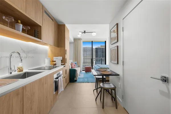 a view of a kitchen with a sink and cabinets