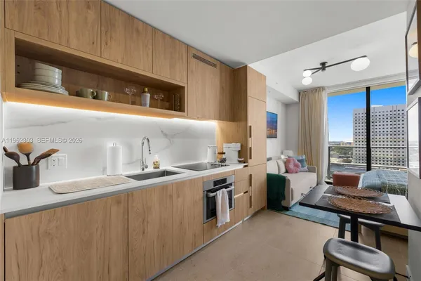 a kitchen with a sink stove and cabinets