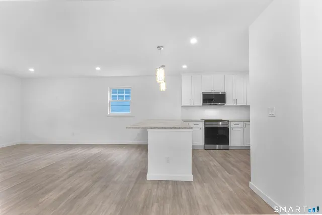 a kitchen with granite countertop a stove and a sink