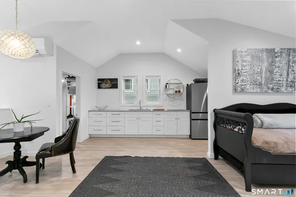a kitchen with stainless steel appliances kitchen island granite countertop a refrigerator and a stove