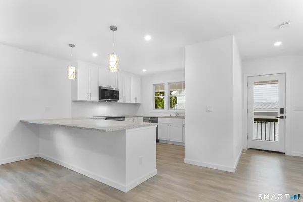 a view of kitchen with cabinets and wooden floor