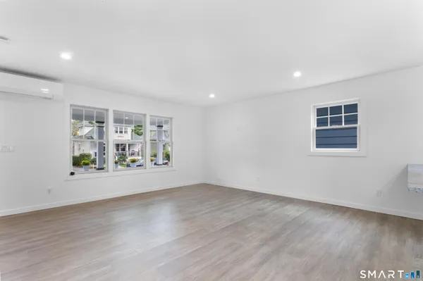 a view of room with window and wooden floor