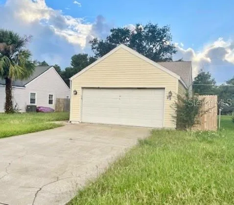 a view of backyard of house and garage