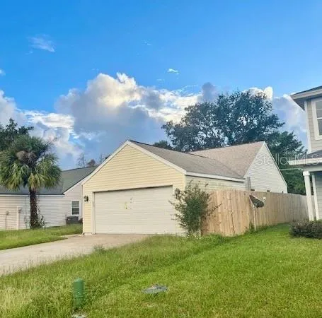 a view of a yard in front of a house with large trees