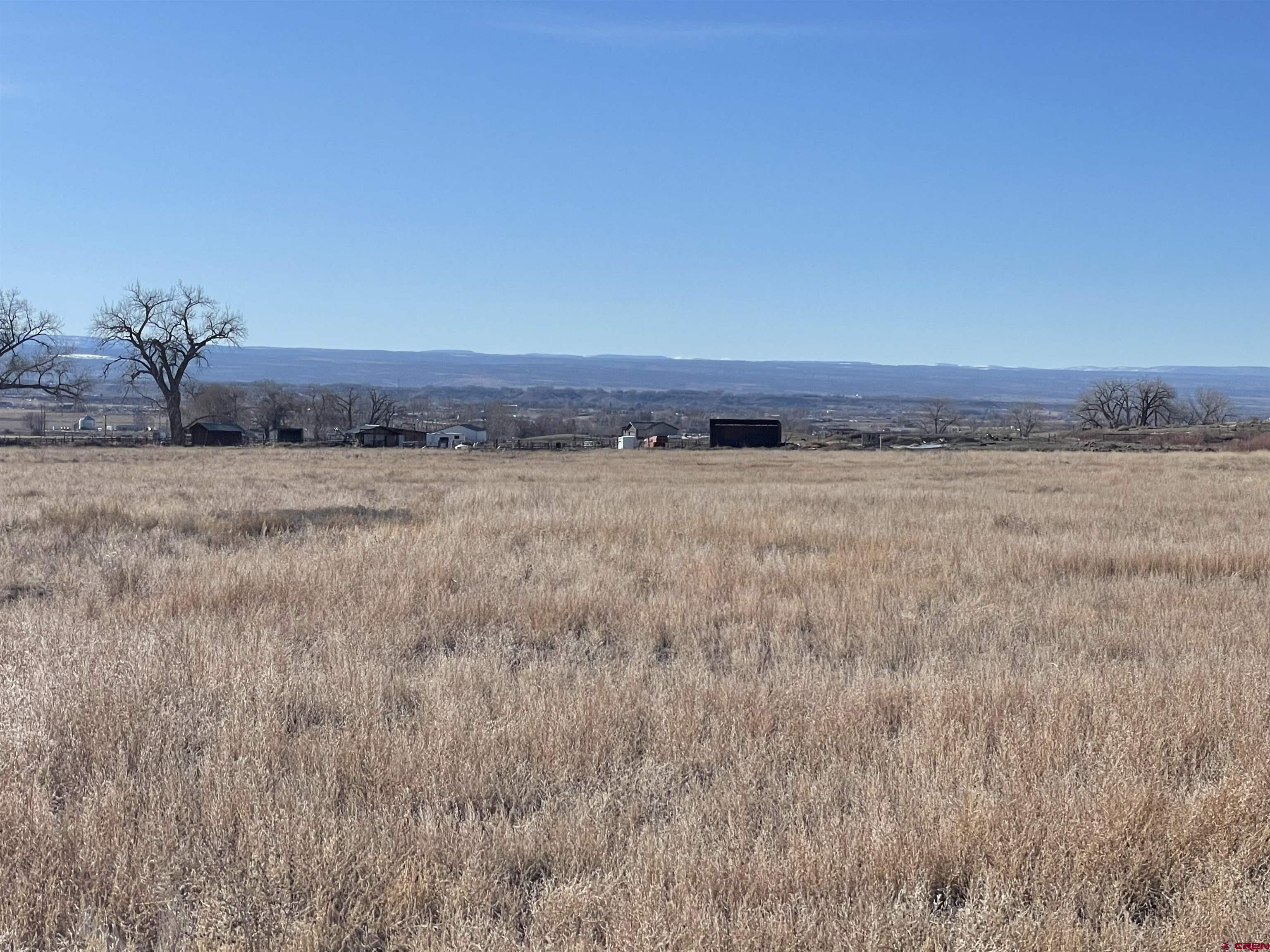 64233 Peach Valley Road Montrose, CO 81401 - Photo 17 of 26 a view of a field with wooden fence