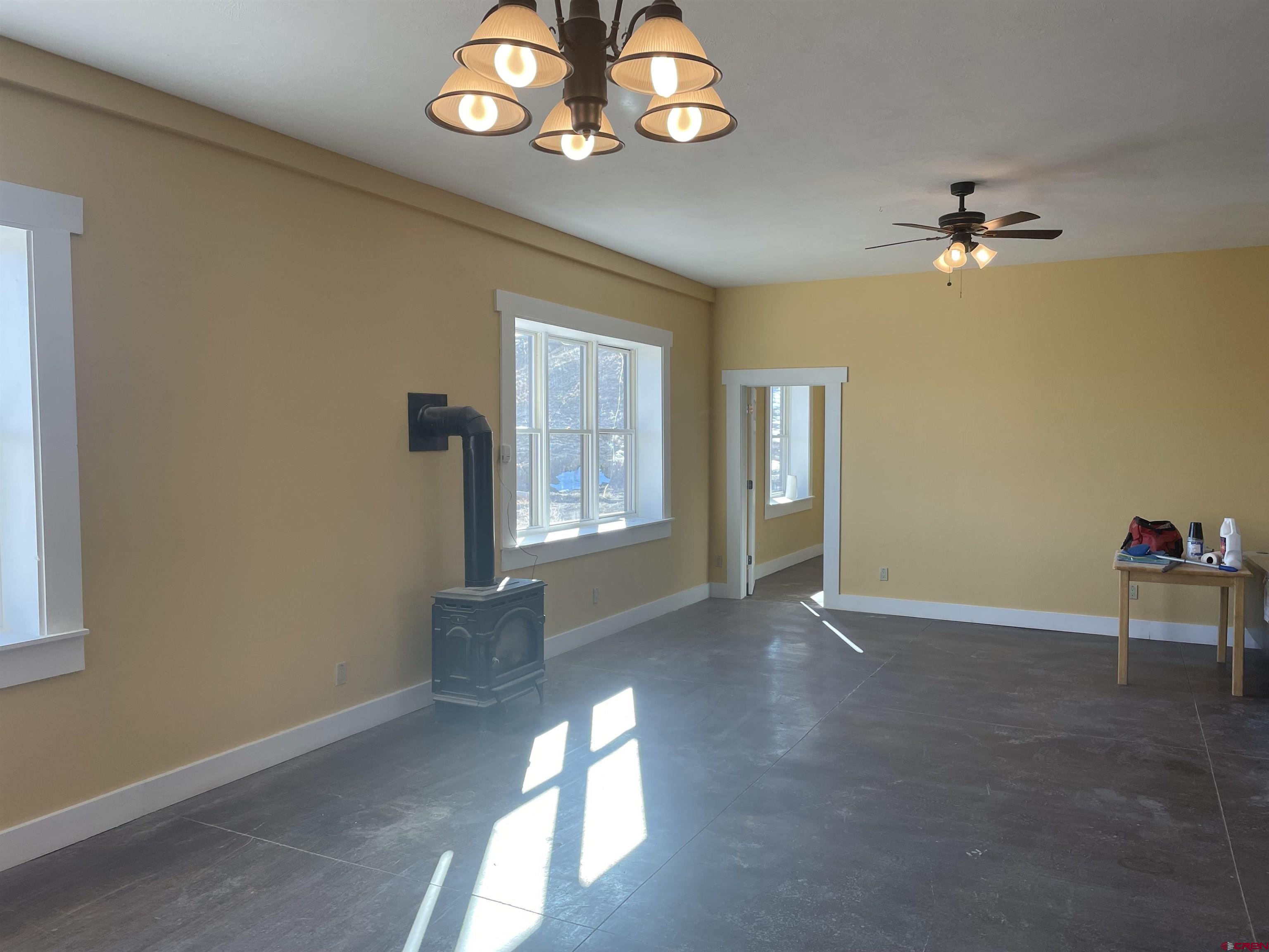 64233 Peach Valley Road Montrose, CO 81401 - Photo 5 of 26 wooden floor in an empty room with a window