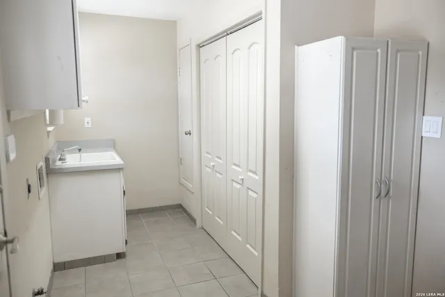 a view of a storage & utility room with a sink