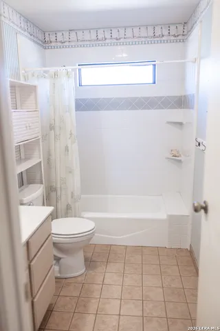 a bathroom with a toilet a sink and shower