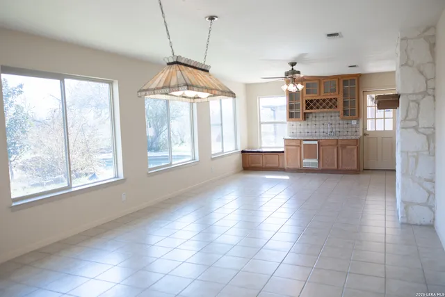 a kitchen with stainless steel appliances granite countertop a stove a sink dishwasher and a large window with kitchen view