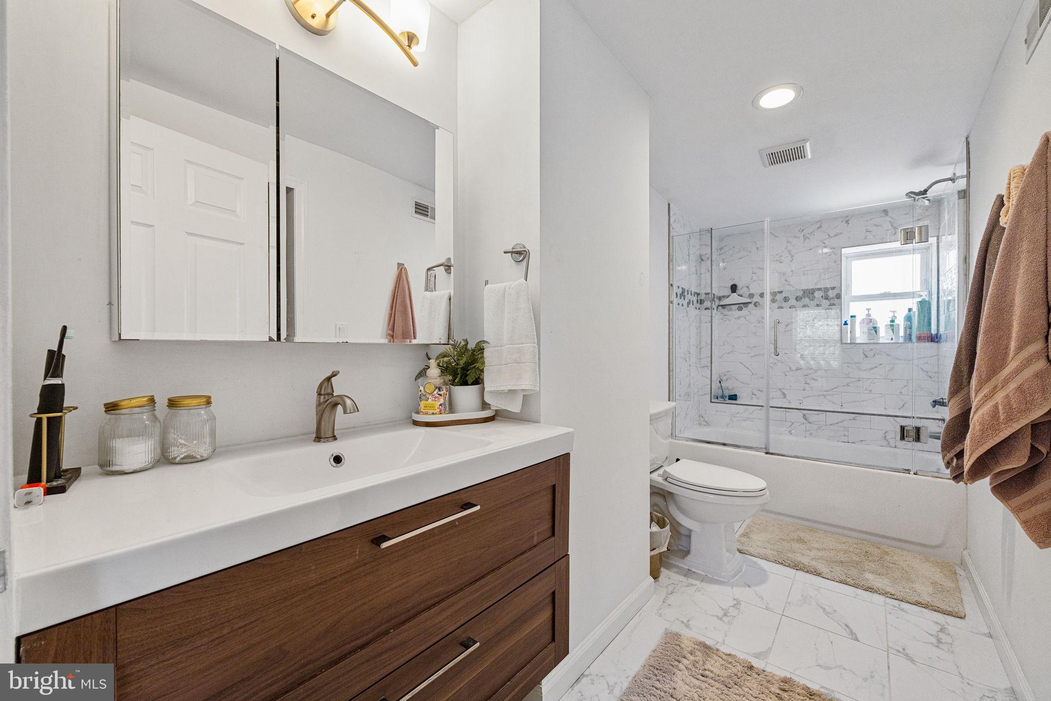 744 South 19th Street Philadelphia, PA 19146 - Photo 18 of 29 a bathroom with a sink a toilet and shower