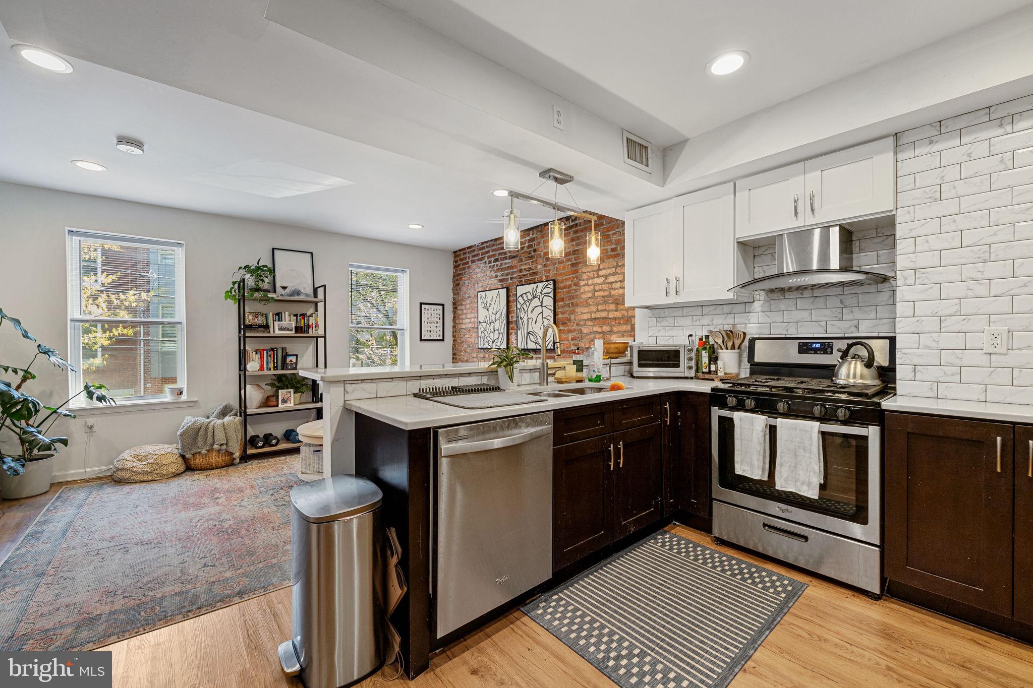 744 South 19th Street Philadelphia, PA 19146 - Photo 6 of 29 a kitchen with stainless steel appliances granite countertop a stove and cabinets