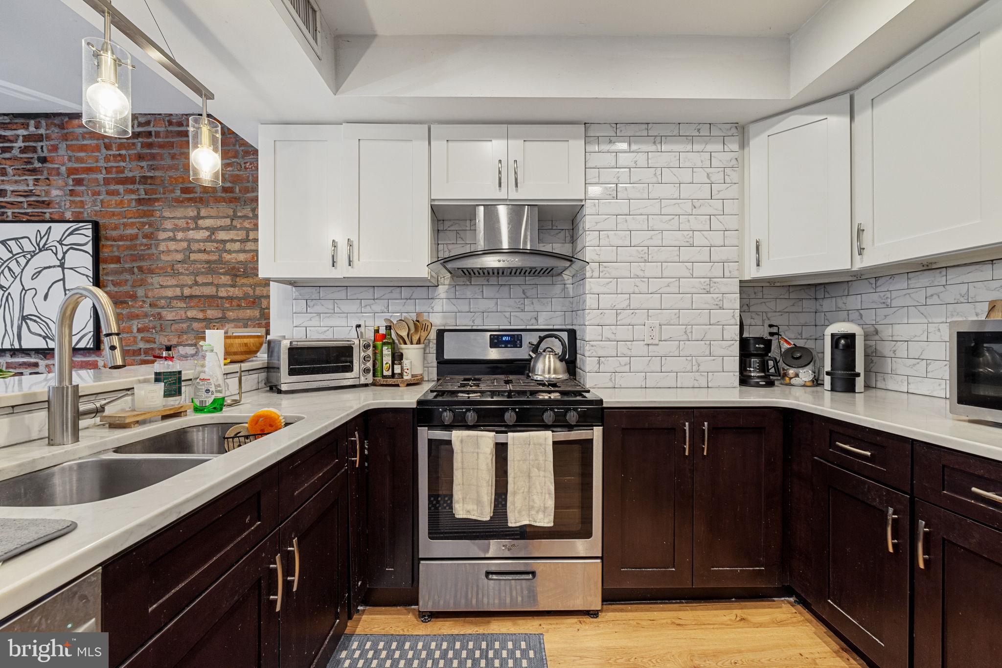 744 South 19th Street Philadelphia, PA 19146 - Photo 7 of 29 a kitchen with stainless steel appliances a sink stove and cabinets