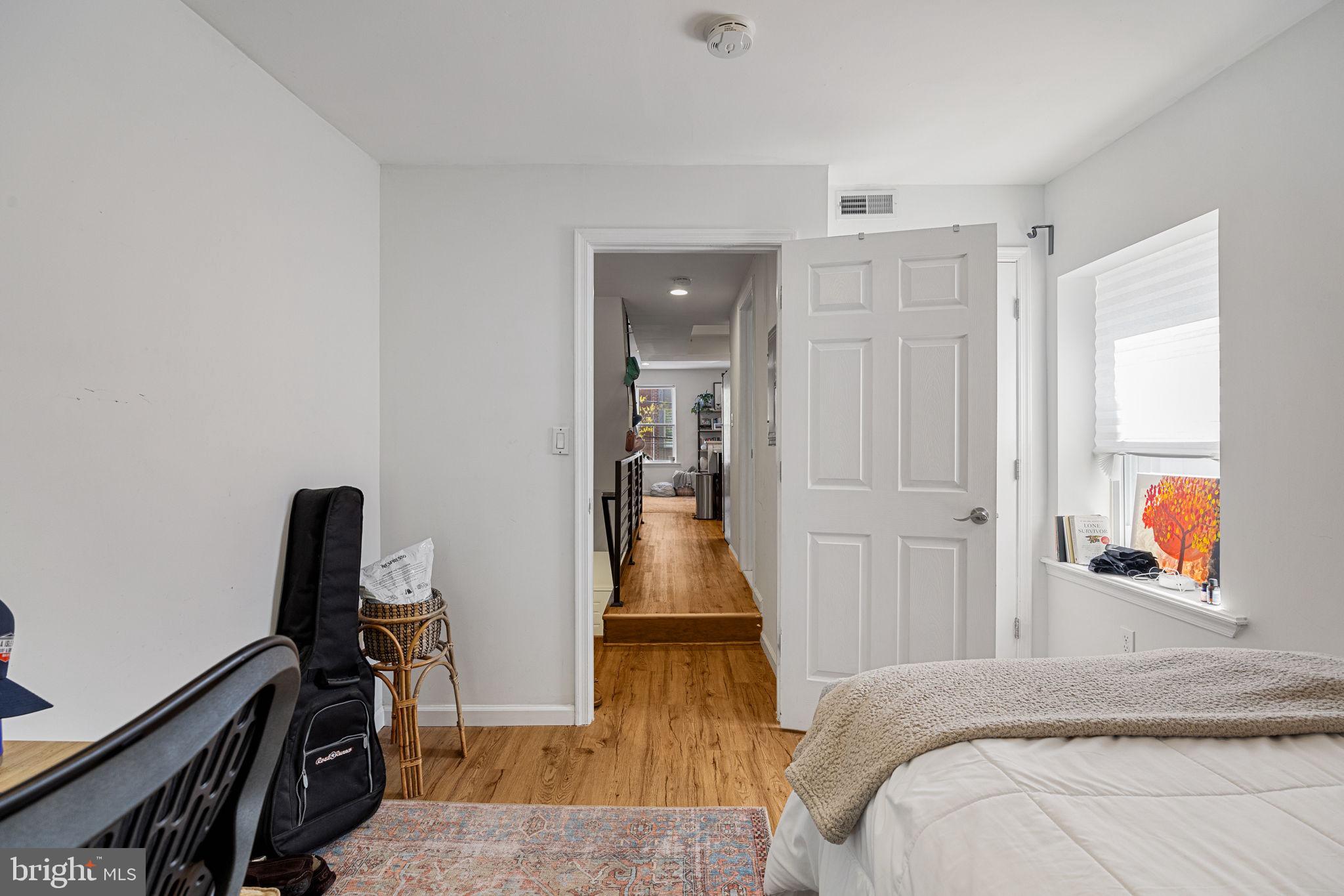 744 South 19th Street Philadelphia, PA 19146 - Photo 9 of 29 a bedroom with a bed and wooden floor