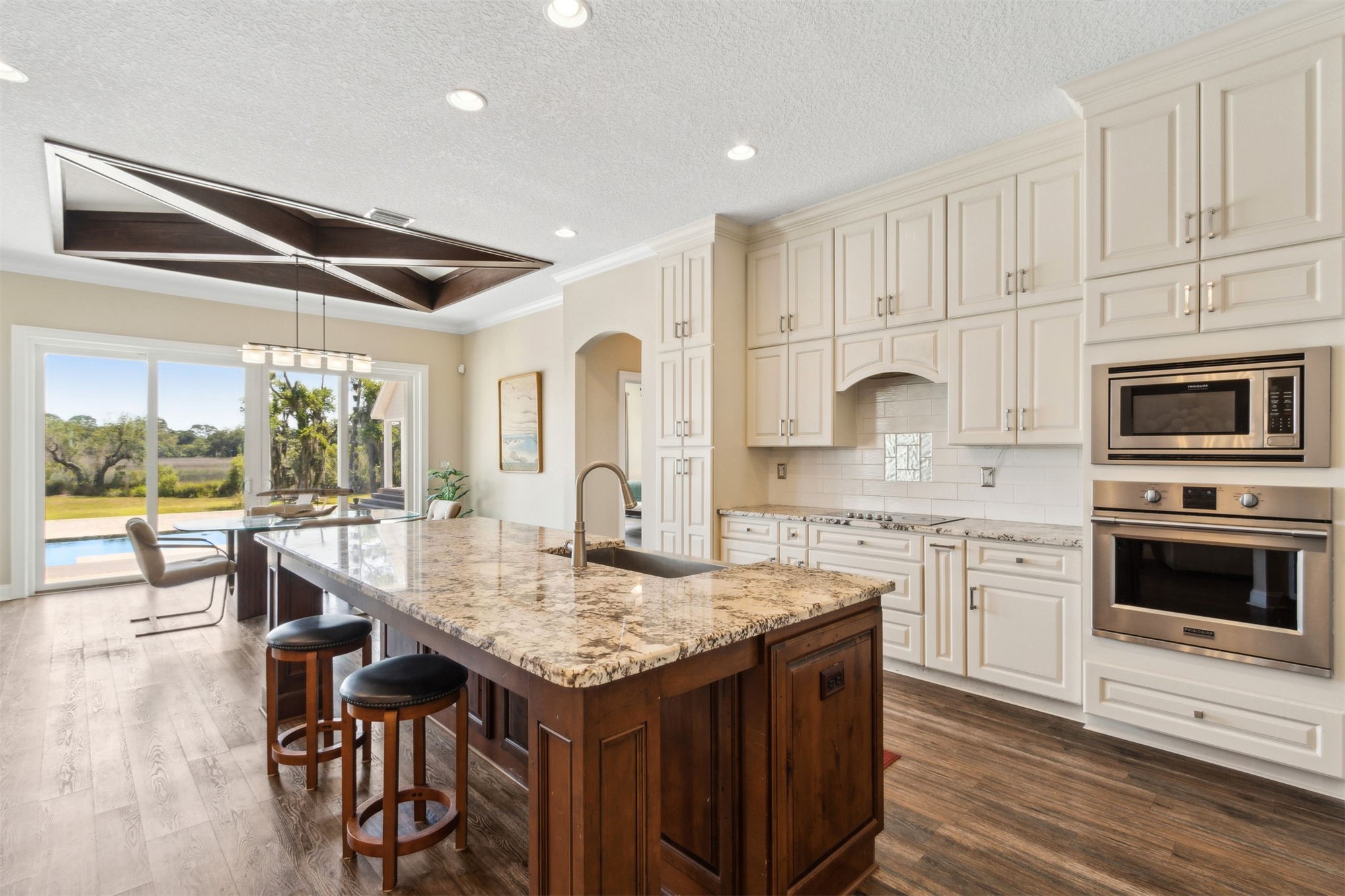 1900 Sycamore Lane Fernandina Beach, FL 32034 - Photo 11 of 54 a kitchen with granite countertop kitchen island white cabinets and stainless steel appliances