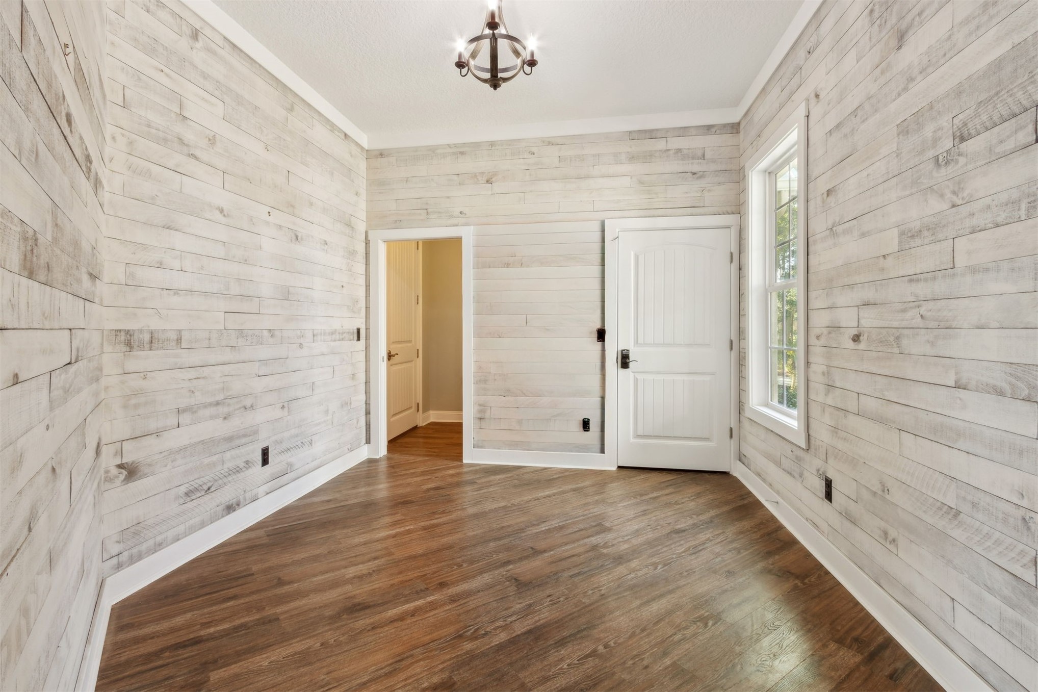 1900 Sycamore Lane Fernandina Beach, FL 32034 - Photo 18 of 54 a view of an empty room with wooden floor and a window