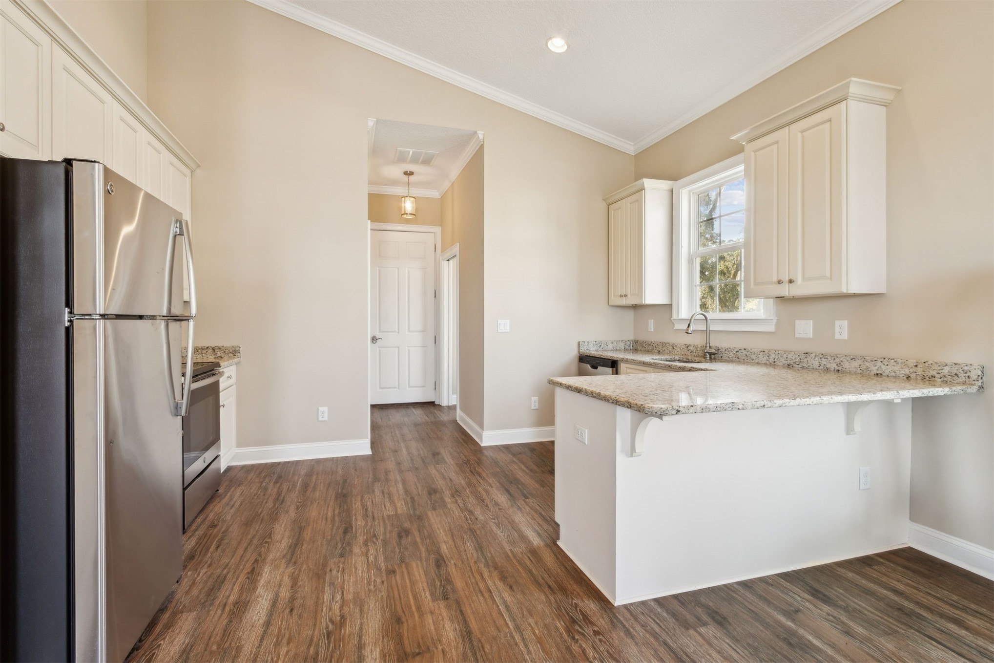 1900 Sycamore Lane Fernandina Beach, FL 32034 - Photo 34 of 54 a kitchen with a refrigerator wooden floor and a sink