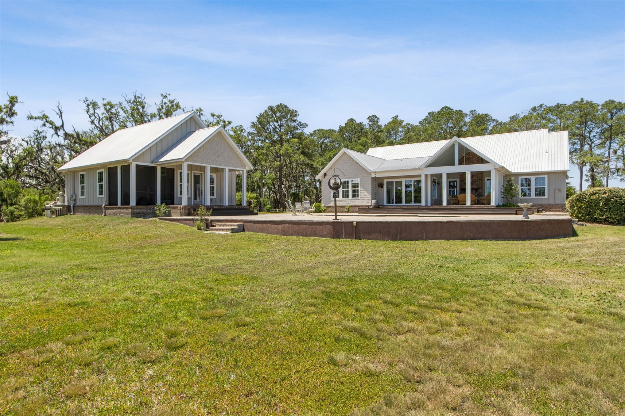 1900 Sycamore Lane Fernandina Beach, FL 32034 - Photo 41 of 54 a front view of a house with a yard table and chairs