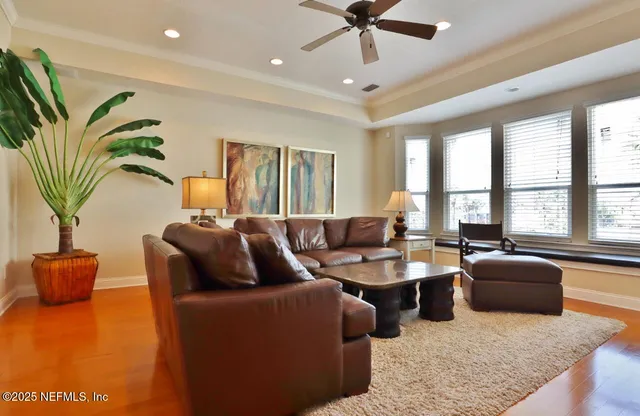 a living room with furniture potted plant and a large window