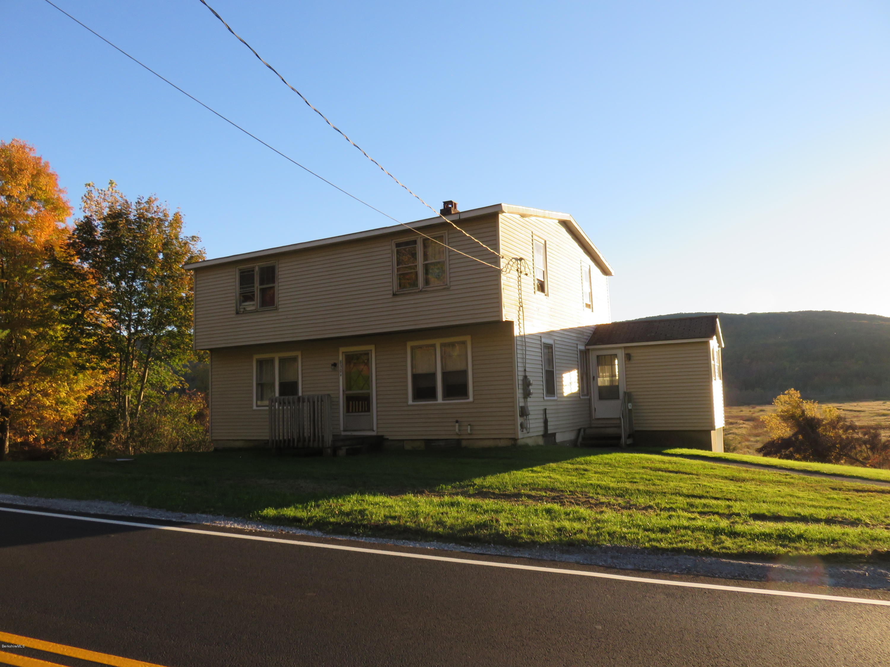 800 Tyringham Road Lee, MA 01238 - Photo 8 of 19 a view of a house with a small yard and a large tree